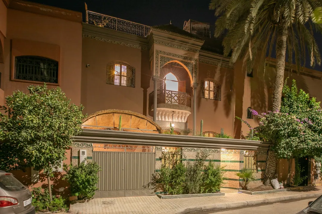 The riad façade softly lit at night