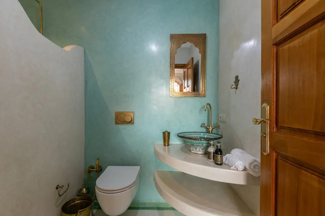 Jade room bathroom with a turquoise copper basin and tadelakt shower