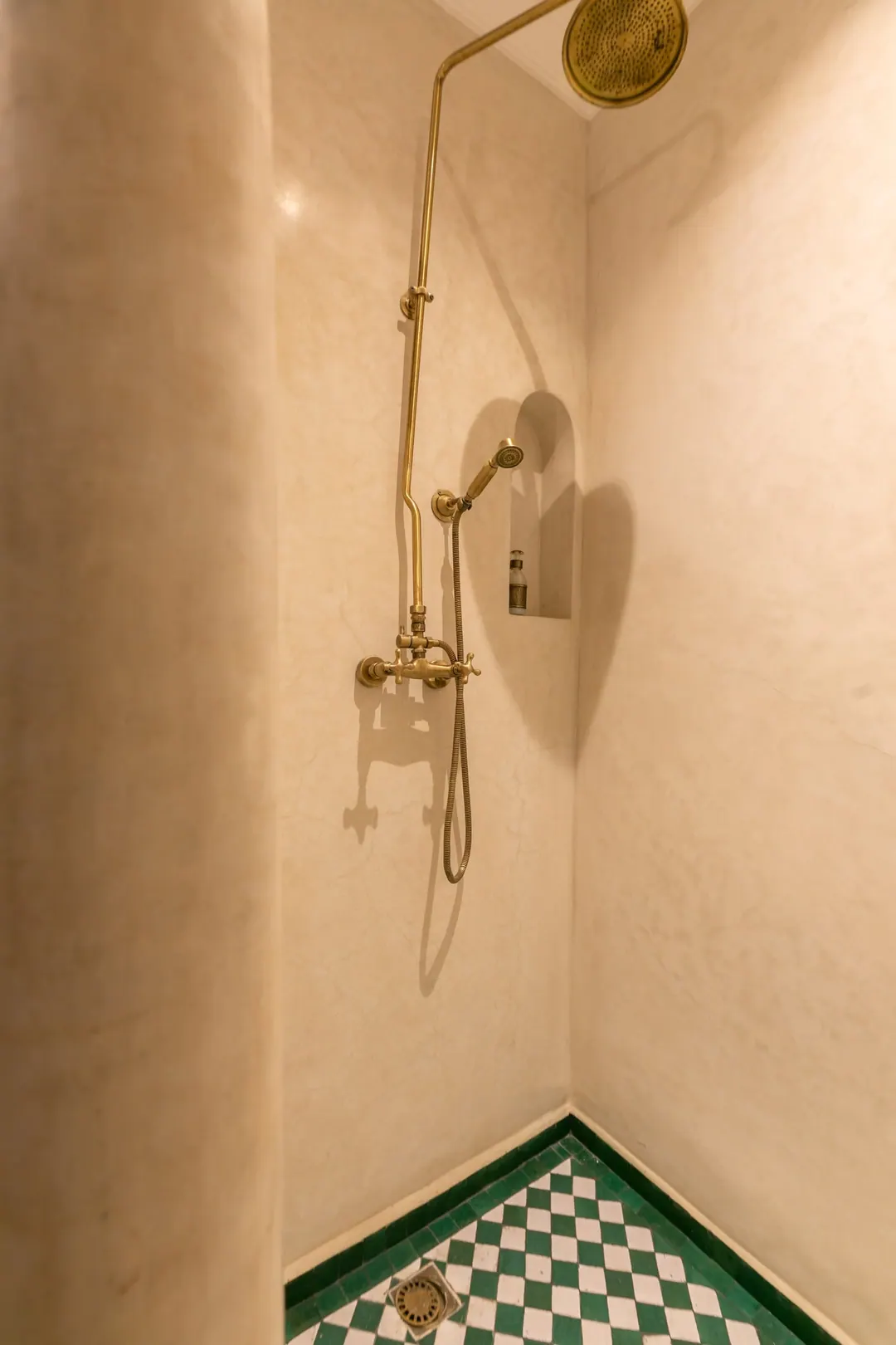 Emerald room bathroom with a hand-glazed green basin and brass fittings