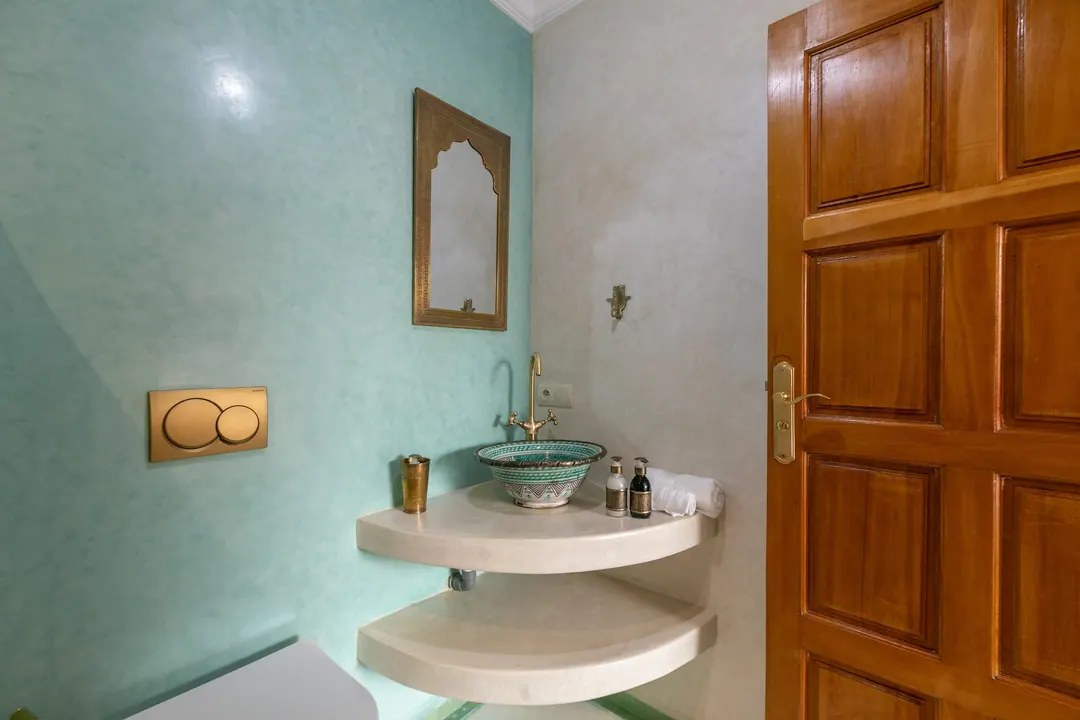 Jade room bathroom with a turquoise copper basin and tadelakt shower
