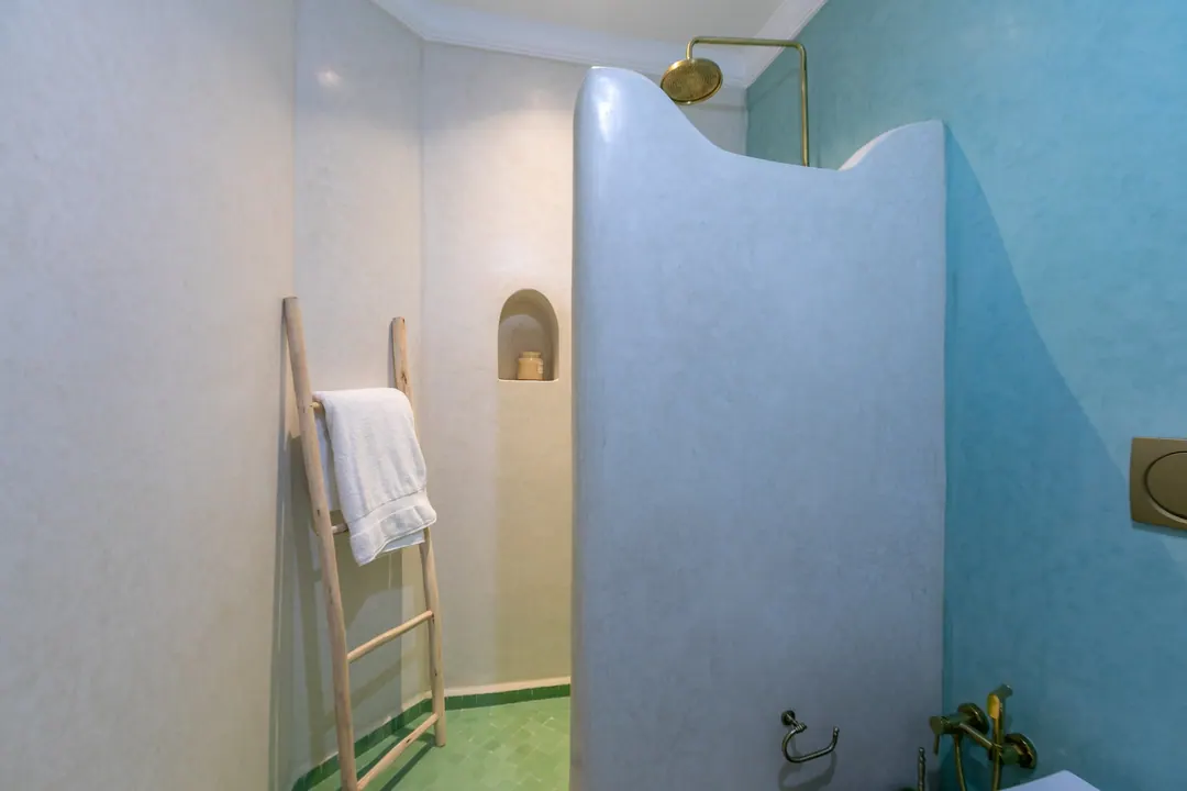 Jade room bathroom with a turquoise copper basin and tadelakt shower