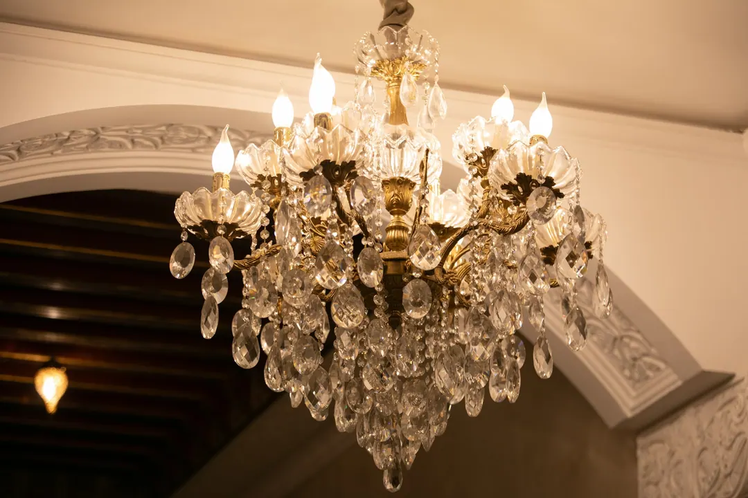 Crystal chandelier beneath a carved plaster arch