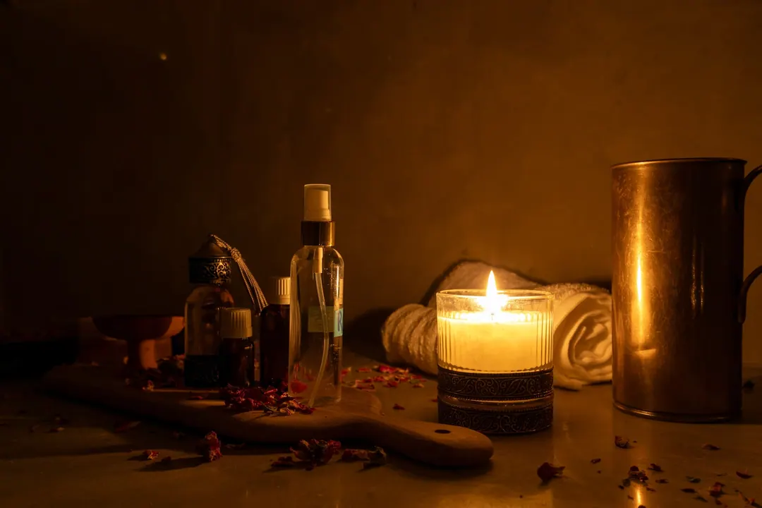 Hammam ritual: black soap, argan oil, rose petals and warm towels by candlelight
