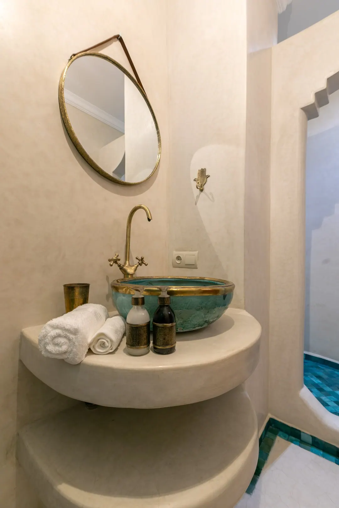 Turquoise room bathroom with a copper basin and blue mosaic shower