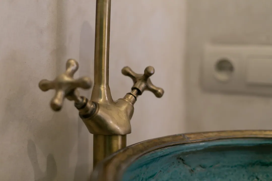 Jade room bathroom with a turquoise copper basin and tadelakt shower