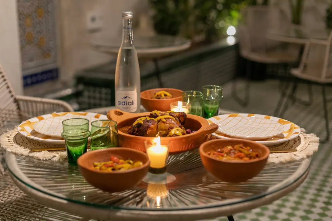 Candle-lit dinner of chicken tagine with preserved lemon and Moroccan salads