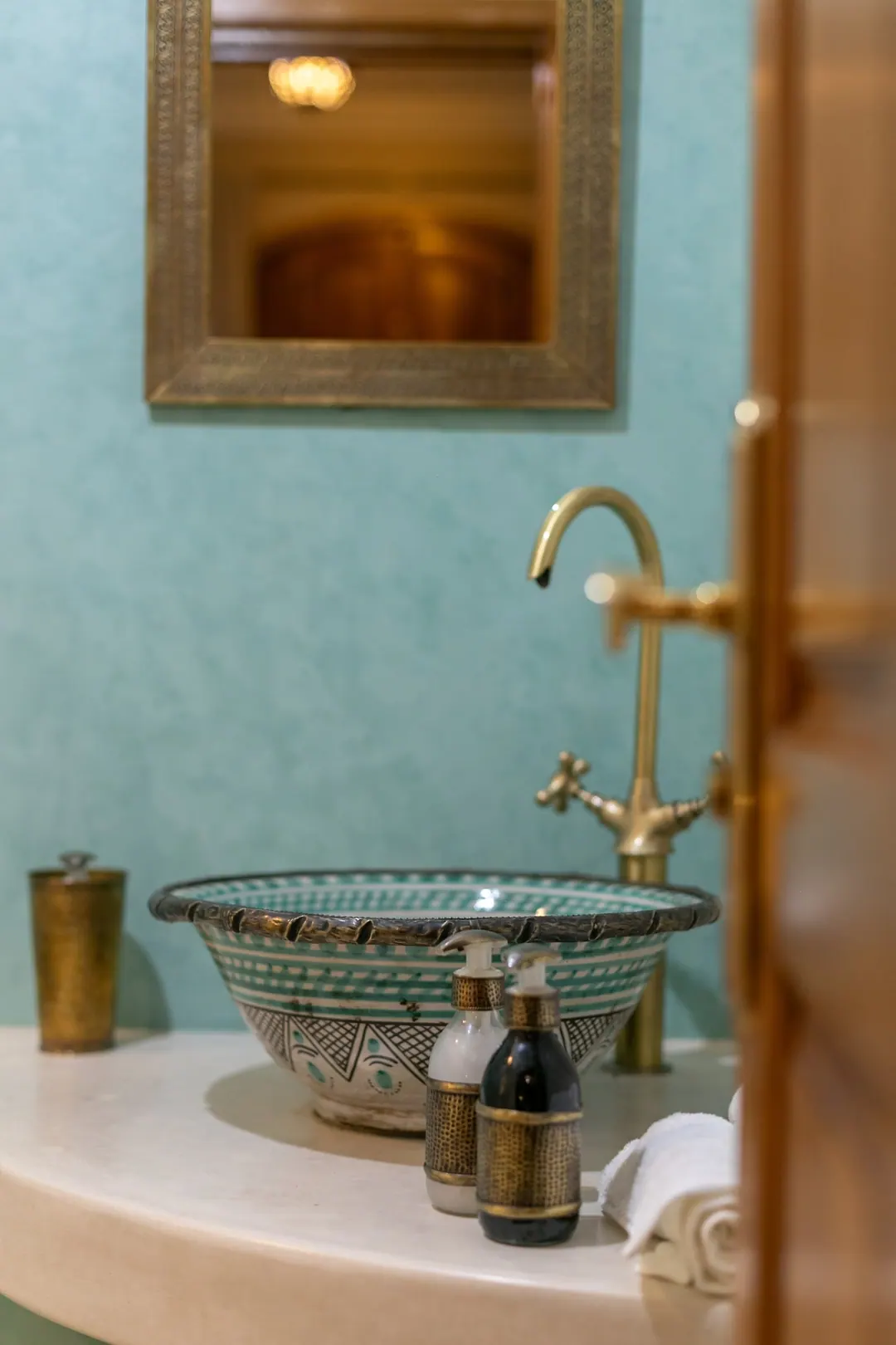 Jade room bathroom with a turquoise copper basin and tadelakt shower