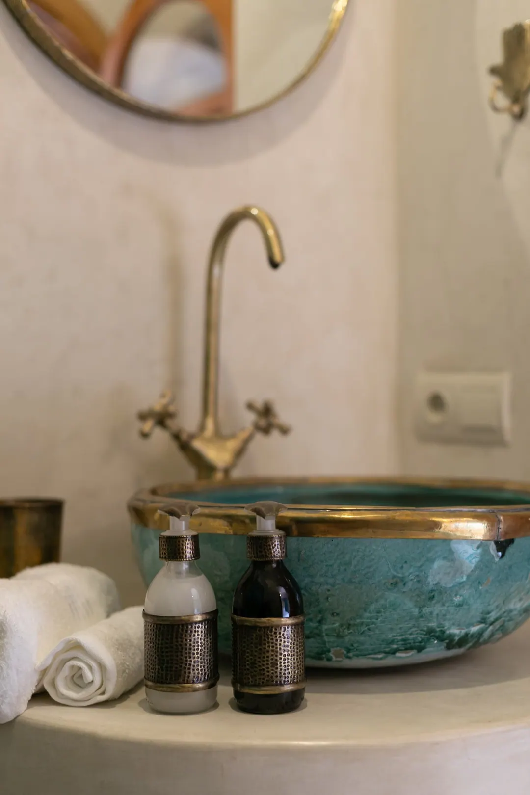 Jade room bathroom with a turquoise copper basin and tadelakt shower