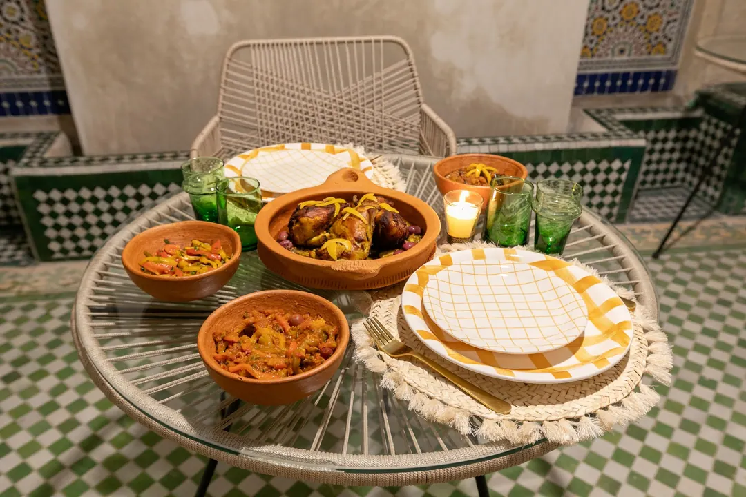 Candle-lit dinner of chicken tagine with preserved lemon and Moroccan salads