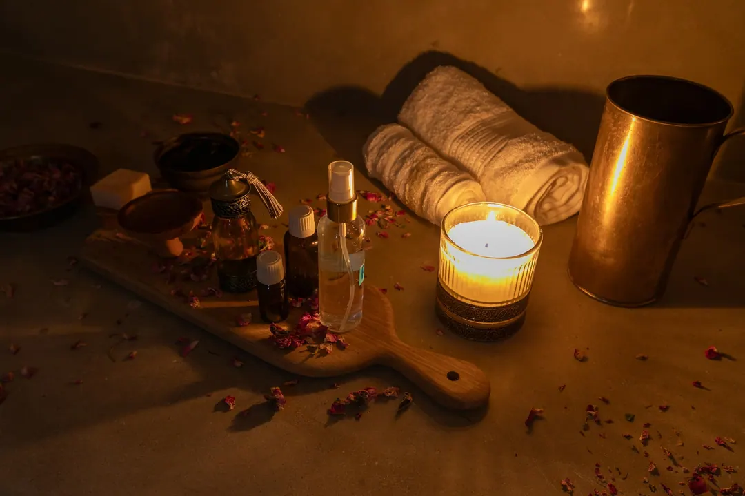 Hammam ritual: black soap, argan oil, rose petals and warm towels by candlelight