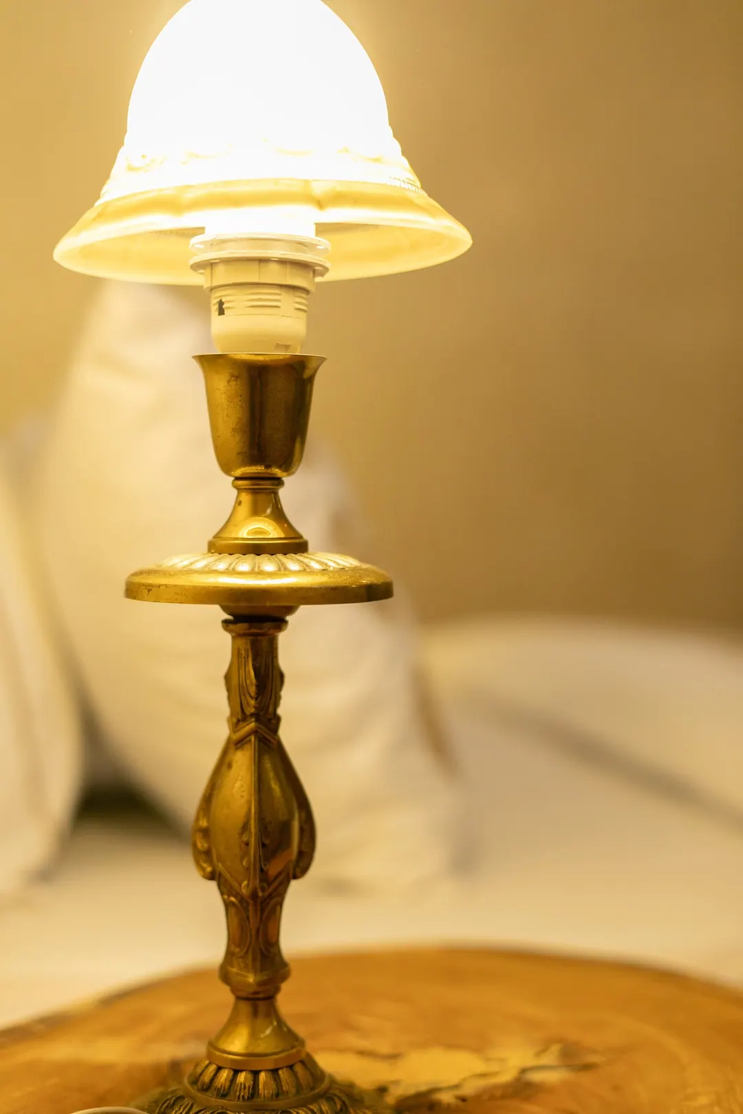 Ivory room: carved plaster headboard, bedside lamps and a black-and-white zellige floor
