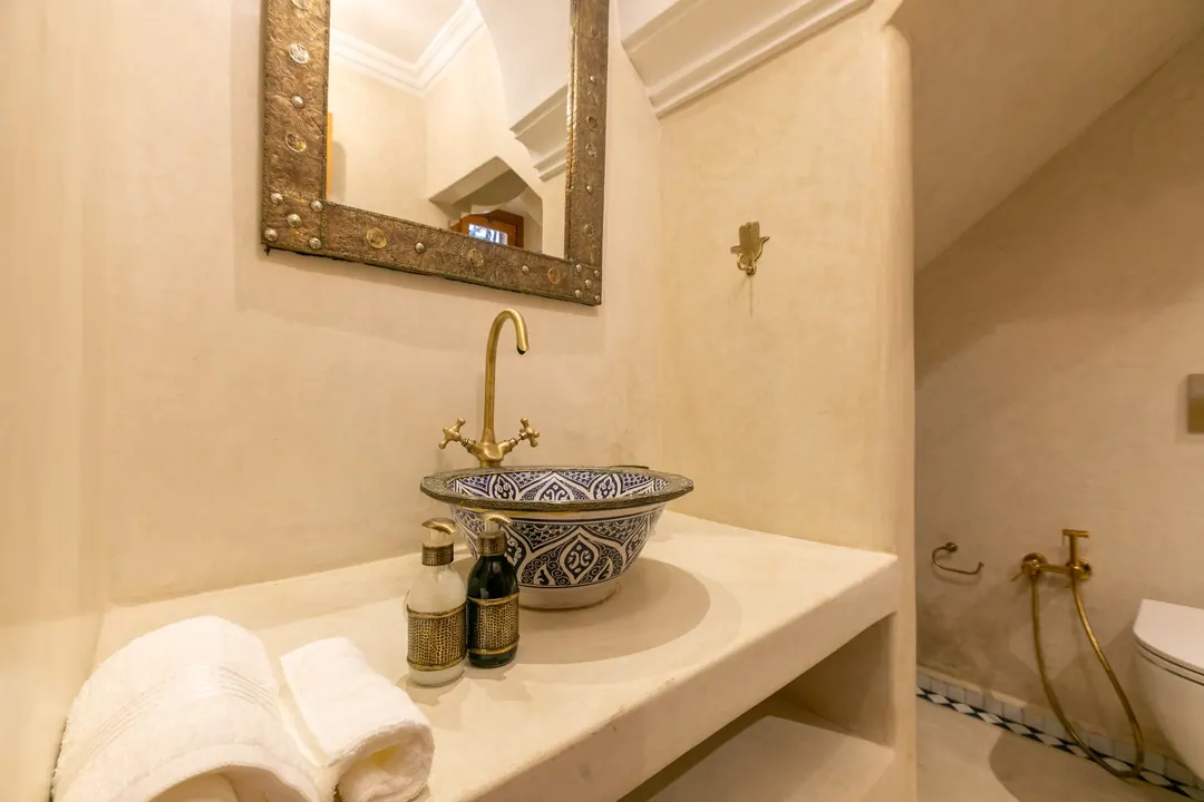 Ivory room bathroom with a blue-and-white Fez ceramic basin