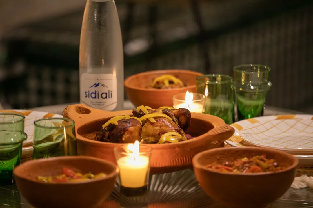 Candle-lit dinner of chicken tagine with preserved lemon and Moroccan salads