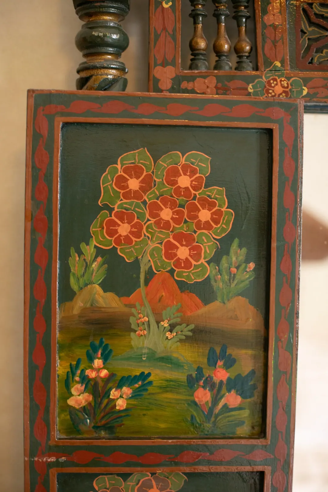 Emerald room: carved headboard on an emerald tadelakt wall, green lantern and zellige floor