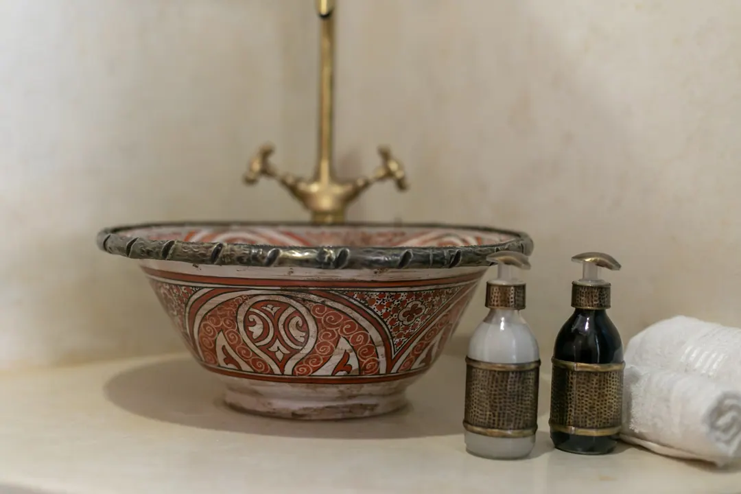 Hand-painted ceramic basin with a brass tap